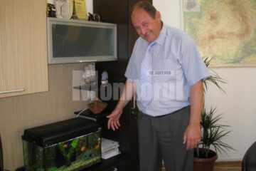 Primarul Andriciuc și acvariul cu cei 15 peștișori simbolizând Consiliul Local Șcheia