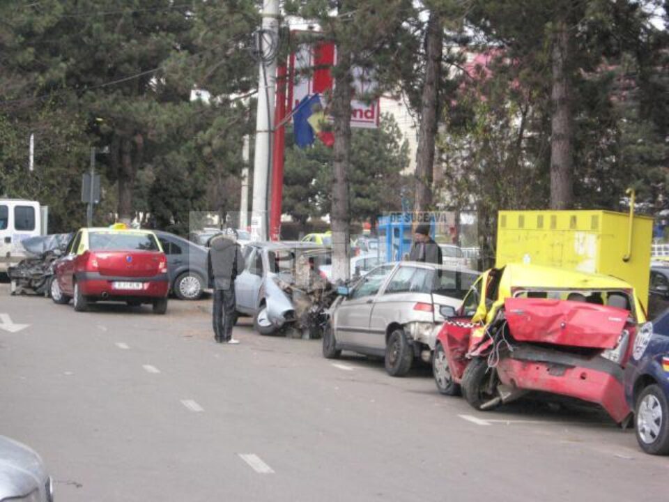 Trecătorii privesc mașinile transformate în mormane de fiare Trecătorii privesc mașinile transformate în mormane de fiare