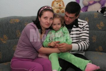 Micuța Claudia, în brațele părinților săi, Valentina și Victor Timinger