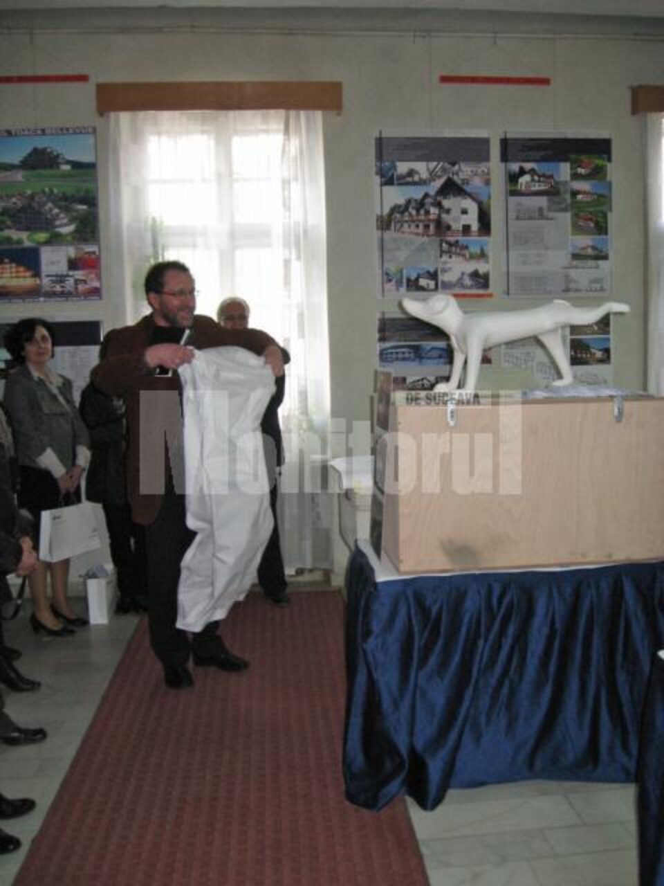 Arh. Constantin Gorcea, președintele OAR - Filiala Nord-Est, dezvelind obiectul nomad trimis spre adopție filialei