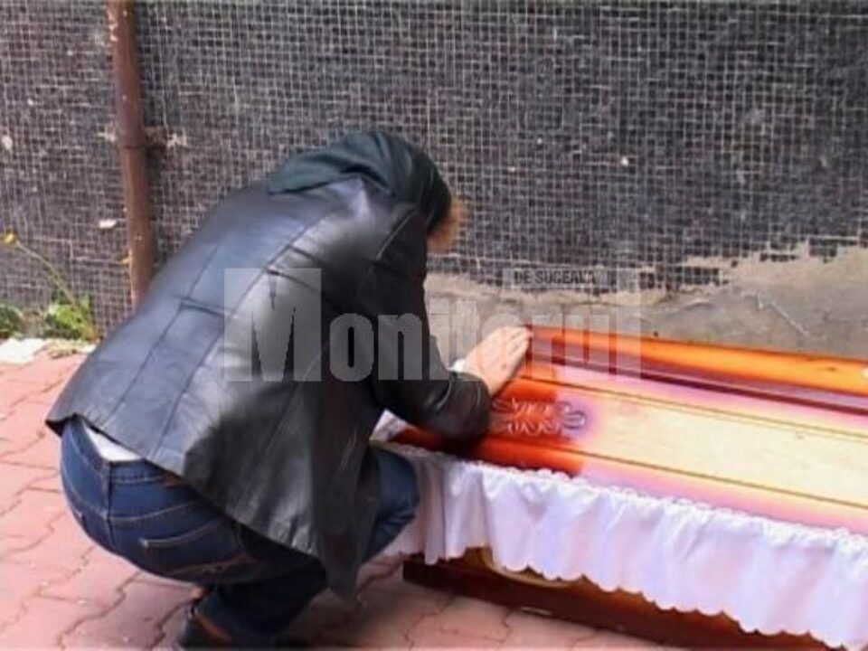 Mama lui Eugen Ursariu plângându-și fiul lângă sicriu