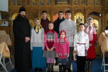 Copiii care se pregătesc de colindat, alături de preotul Ștefan Andrian