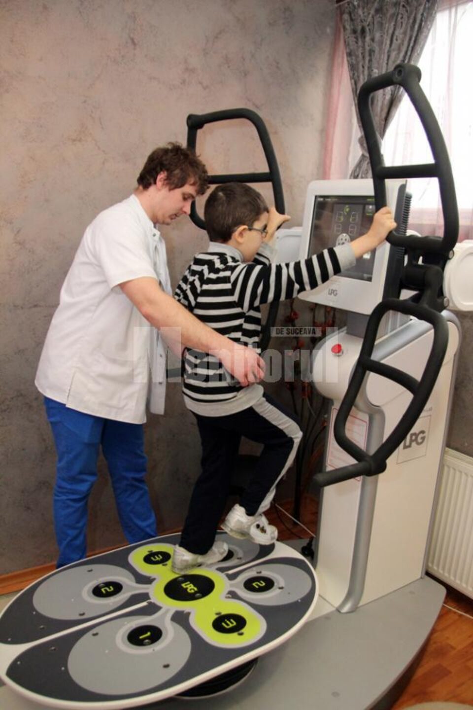 Denis în timpul unei ședințe pe Huber Motion Lab, ajutat de kinoterapeutul George Morari Denis în timpul unei ședințe pe Huber Motion Lab, ajutat de kinoterapeutul George Morari