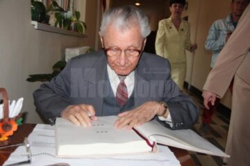 Primul director al unității - Mihai Filip - scriind gânduri în cartea de onoare a școli