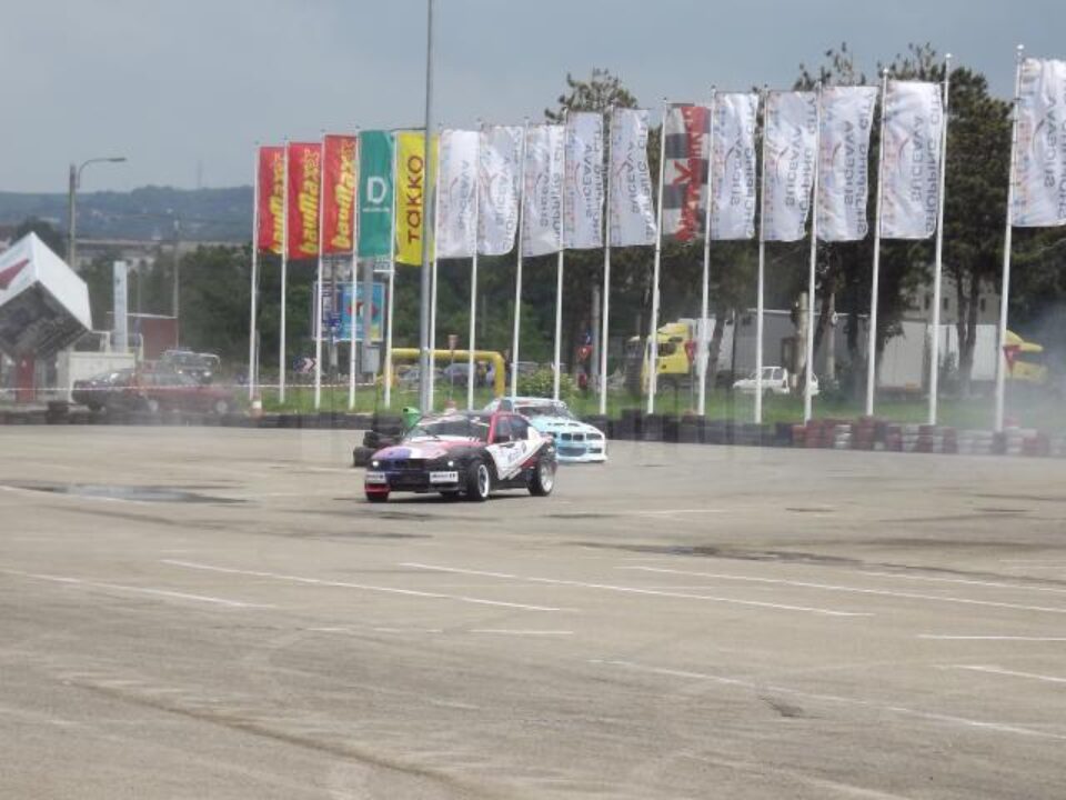 Două mașini BMW executând derapaje controlate