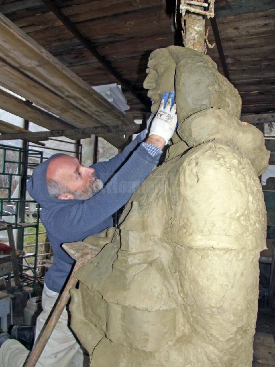 Sculptorul Mircea Dăneasă lucrând la monument