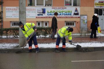 Trei echipe ale Diasil adună mormane de pietriș, nisip și pământ din rigolele stradale