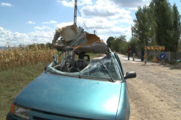 Cupola unui autoturism care circula pe un drum din orașul Liteni, strivită de un excavator