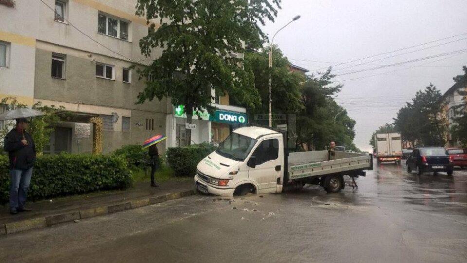 Autoutilitara prăbușită în asfaltul care s-a surpat pe strada Mihai Viteazul, lângă Policlinica din Areni