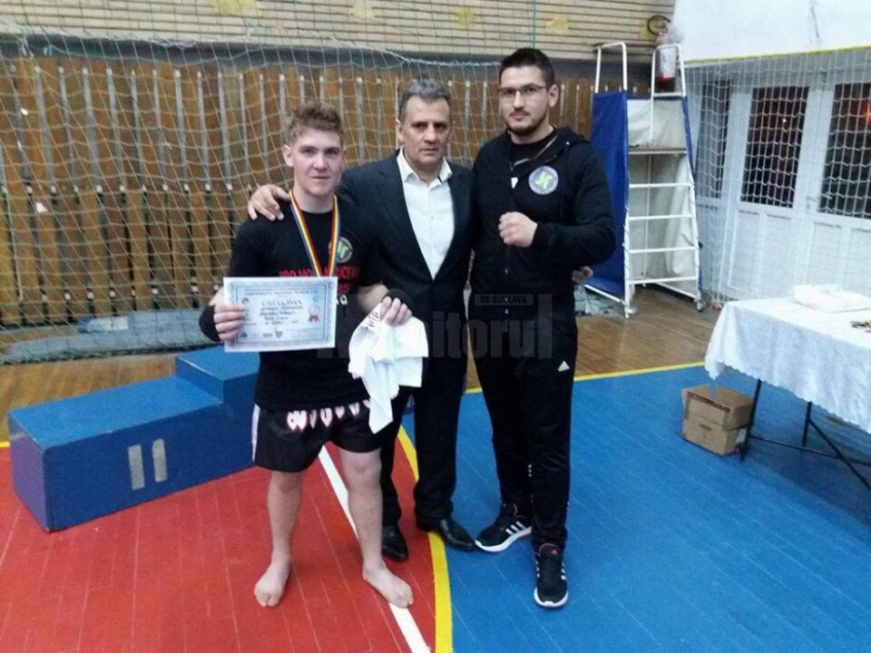 Răduțeanul Alexandru Lupancu alături de instructorul Paul Ghețău și Ion Gârbea (mijloc), reprezentantul federației pe kickbox