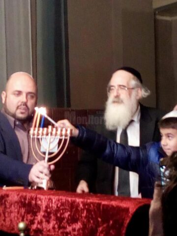 Flacăra pentru lumânările de Hanuka, oferită la Suceava de prim rabinul Rafael Schaffer, unui copil de 8 ani
