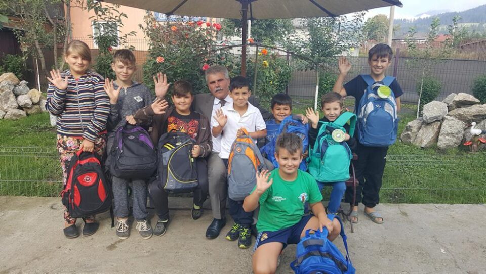 Mihăiță Negură alături de elevii care au primit rechizite