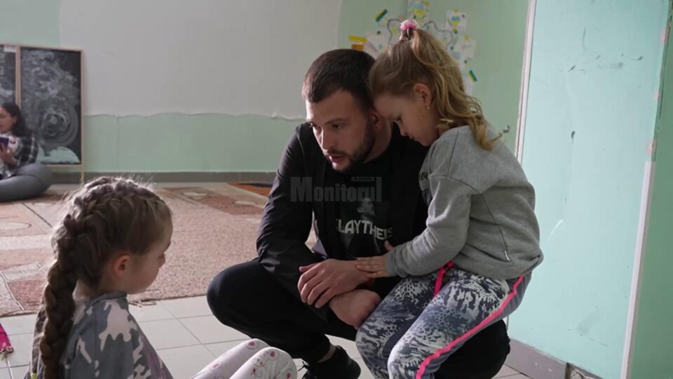 Dumitru lângă două fetițe refugiate