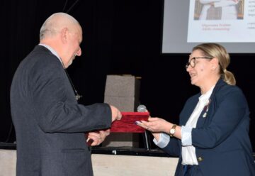 Prof. Brândușa Nisioi, directoarea Școlii Gimnaziale „Alexandru Ioan Cuza”, oferă diploma de recunoștință
