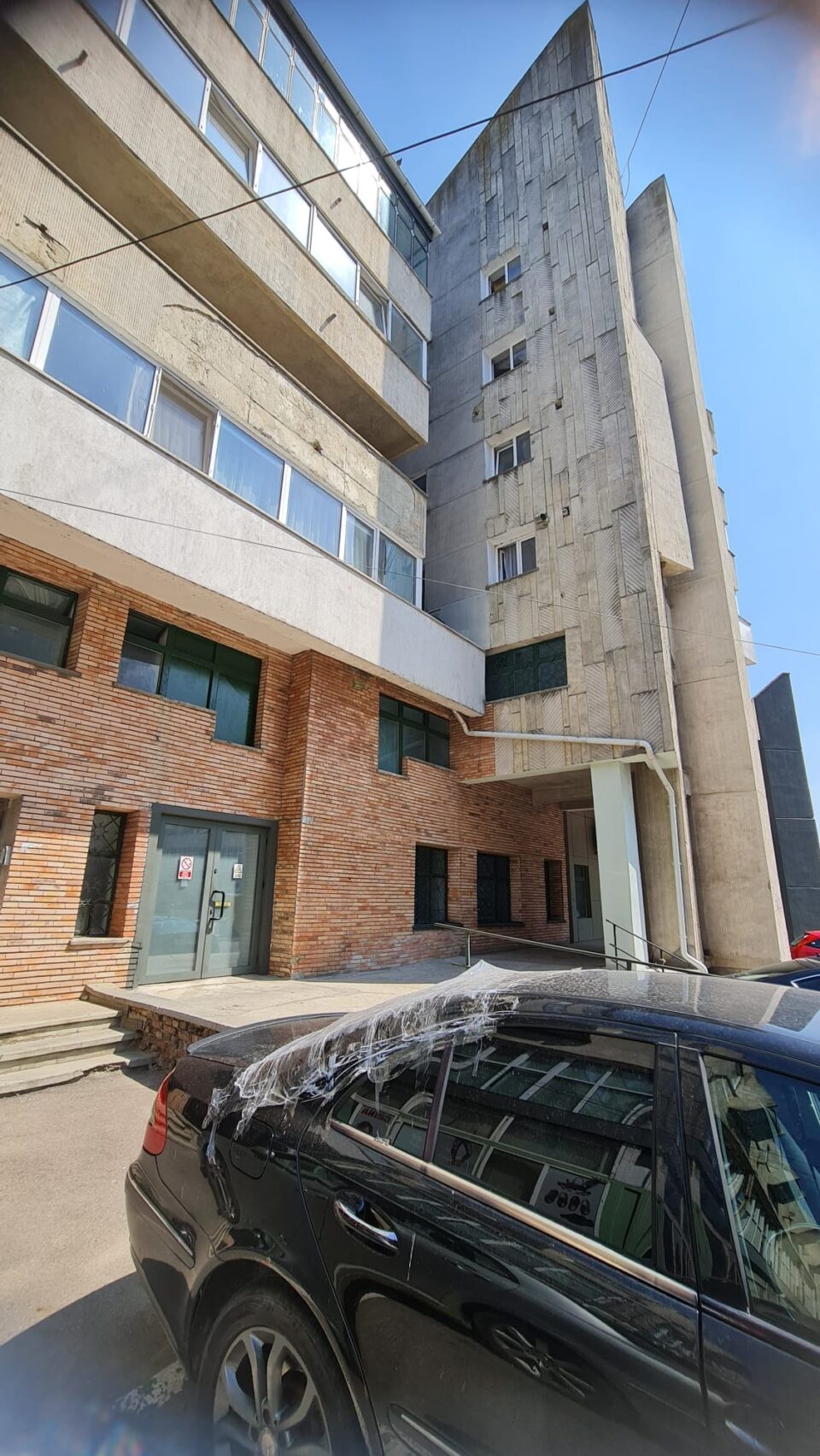 Autoturismul a cărui lunetă a fost spartă de bucățile de tencuială căzute de pe bloc